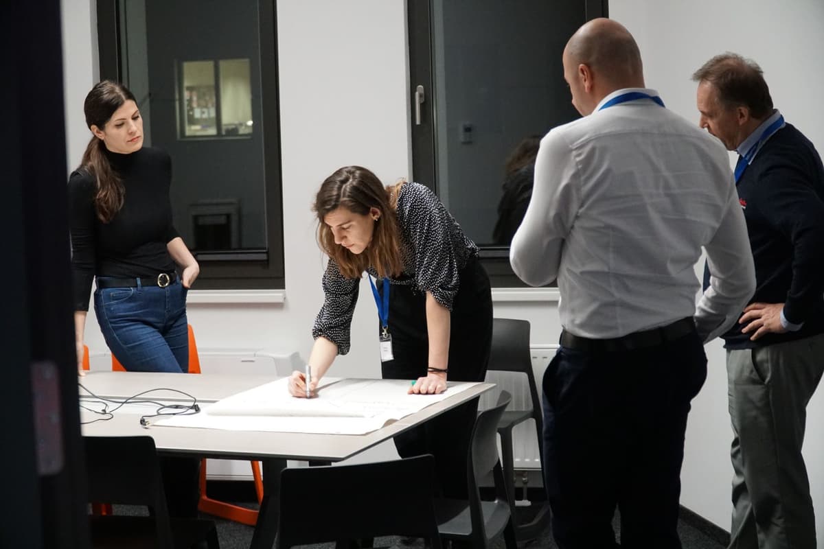 Woman drawing on paper in meeting room